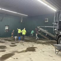 Workers pouring concrete foundation for Chenango SportsZone facility