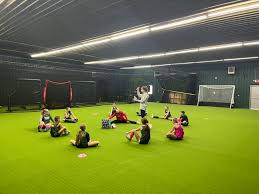 Young girls participating in a soccer training session on the indoor turf