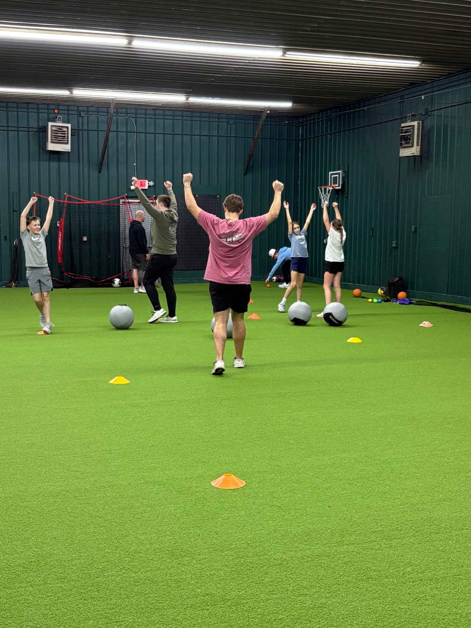 Girls softball group training session on indoor turf at Chenango SportsZone
