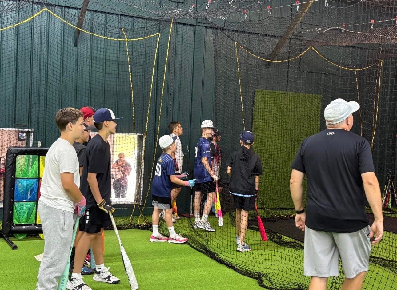 Teens doing agility training with cones and medicine balls on the indoor turf