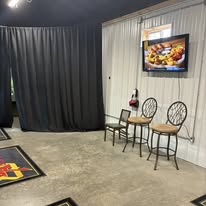 Seating area with bistro table, chairs, and wall-mounted TV